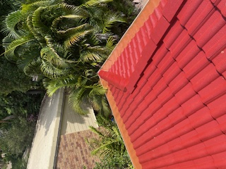 Clean gutters on residential red tile roof